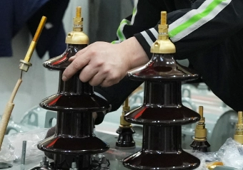OMEK Power's workers are installing the insulating bushing for a 20kv transformer
