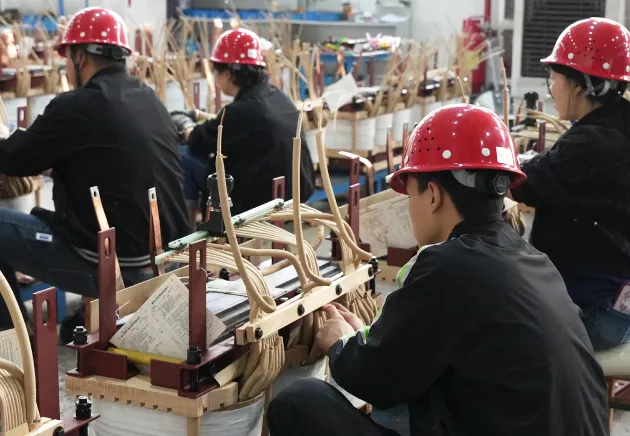 omek power's workers are operating transformer windings and coils