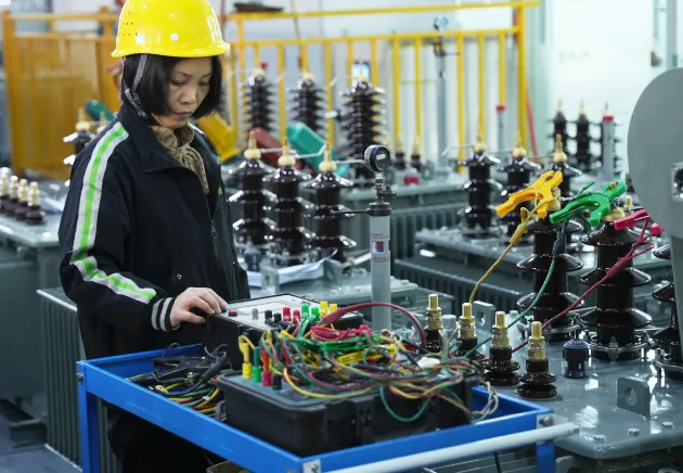 OMEK Power's worker is doing the transformer routine tests
