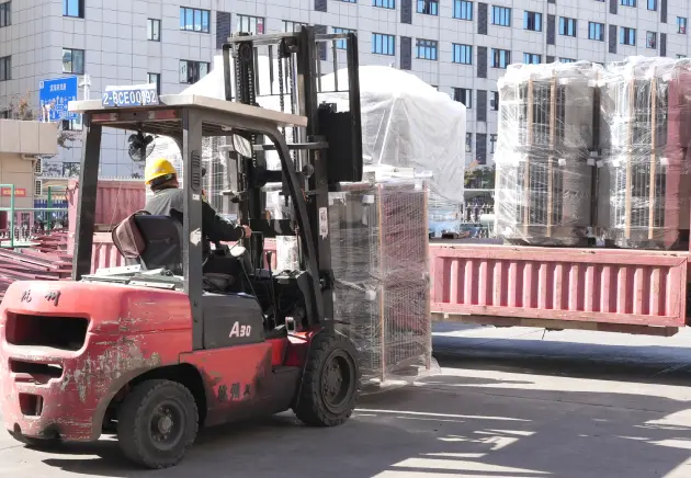 OMEK Warehouse Logistics: 100kVA Pole Mounted Transformer Being Transported on Pallets with Protective Plastic Wrapping for Export