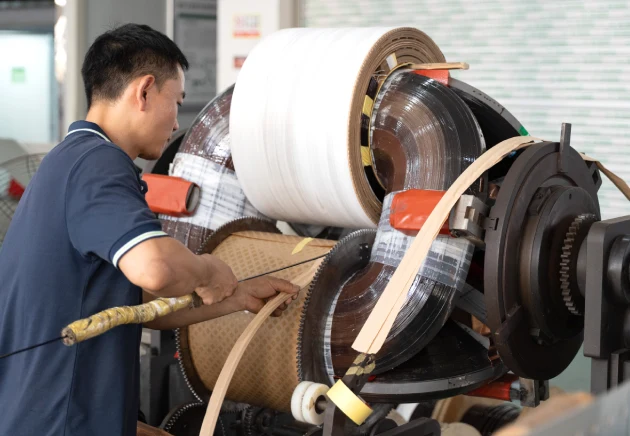 Technician performing custom assembly on a 37.5 kVA pole mounted transformer for OEM customization support