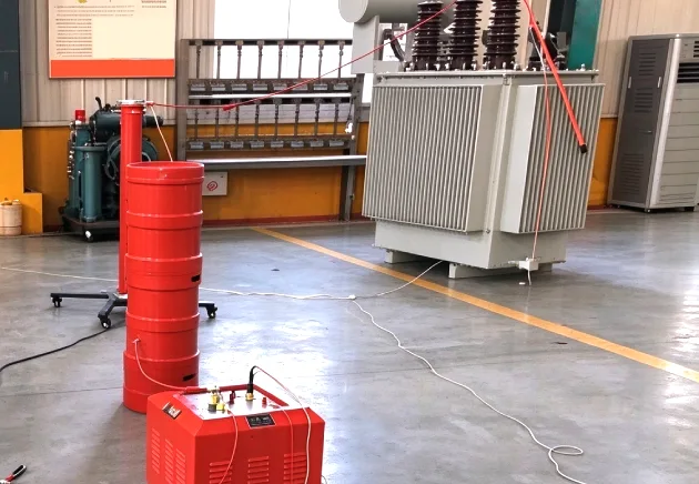 Transformer applied voltage test setup in a factory test bay using high-voltage test cylinder and control unit