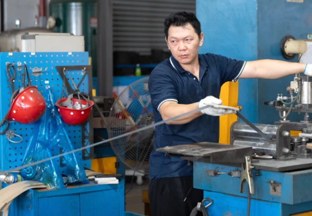 omek power's worker is working on the silicon steel sheet